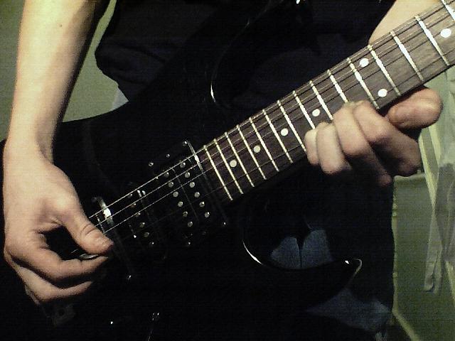Hands playing guitar; Actual size=240 pixels wide